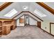 Spacious bonus room with skylights and built-in wooden shelving at 9210 Briarclift Rd, Indianapolis, IN 46256