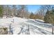 Long driveway leading to the house, covered in snow at 9210 Briarclift Rd, Indianapolis, IN 46256
