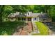 Inviting two-story home with brick and siding, front porch, landscaped yard and attached two-car garage at 9210 Briarclift Rd, Indianapolis, IN 46256