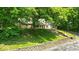 Attractive two-story home with mature trees, brick and siding, front porch and retaining wall at 9210 Briarclift Rd, Indianapolis, IN 46256