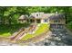 Charming two-story home featuring brick and siding, an attached two-car garage and front retaining wall at 9210 Briarclift Rd, Indianapolis, IN 46256