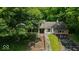 Traditional two-story home featuring a welcoming facade, mature trees, and an attached two-car garage at 9210 Briarclift Rd, Indianapolis, IN 46256