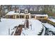 Brick home with snow covered landscaping and a large driveway at 9210 Briarclift Rd, Indianapolis, IN 46256