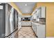 Bright kitchen with stainless steel appliances and tile floors at 9210 Briarclift Rd, Indianapolis, IN 46256