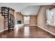 Living room with spiral staircase, fireplace, and hardwood floors at 9210 Briarclift Rd, Indianapolis, IN 46256