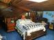 Large bedroom with a wooden bed frame and blue carpet at 941 Sleepy Hollow Pl, Greenwood, IN 46142