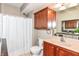 Clean bathroom with shower/tub combo and wood cabinets at 9967 Jasper Ct, Noblesville, IN 46060