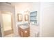 Bathroom with vanity, toilet and access to the laundry room at 10832 Harness Way, Indianapolis, IN 46239
