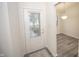Inviting entryway with glass-paneled door and view to the dining area at 10832 Harness Way, Indianapolis, IN 46239