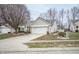 Brick ranch home with attached garage and American flag at 10832 Harness Way, Indianapolis, IN 46239