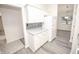 White kitchen cabinets, gray countertops and stainless steel appliances at 10832 Harness Way, Indianapolis, IN 46239