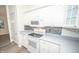 White kitchen with gray countertops and modern appliances at 10832 Harness Way, Indianapolis, IN 46239