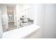 Open kitchen with white cabinets and gray countertops at 10832 Harness Way, Indianapolis, IN 46239