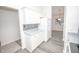 White kitchen with gray countertops and stainless steel appliances at 10832 Harness Way, Indianapolis, IN 46239