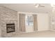Living room with a brick fireplace and large windows at 10832 Harness Way, Indianapolis, IN 46239