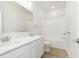 Bright bathroom with double vanity, quartz countertop and tile flooring next to a shower over tub at 10948 Hanovarian St, Zionsville, IN 46077