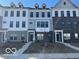 View of new townhomes with brick and vinyl exteriors, front lawns and sidewalks at 10948 Hanovarian St, Zionsville, IN 46077