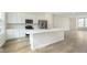 Modern eat-in kitchen features an island, stainless steel appliances, ample cabinets and an open floor plan at 10948 Hanovarian St, Zionsville, IN 46077