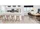 Modern kitchen with white cabinets, island, stainless steel appliances, and hardwood floors at 10948 Hanovarian St, Zionsville, IN 46077