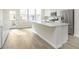 Bright eat-in kitchen features an island, stainless steel appliances, and sliding glass door to balcony at 10948 Hanovarian St, Zionsville, IN 46077