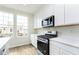 This kitchen features stainless steel appliances, white cabinets, quartz counters and sun-drenched windows at 10948 Hanovarian St, Zionsville, IN 46077