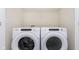 White front load washer and dryer set in a laundry area at 10948 Hanovarian St, Zionsville, IN 46077
