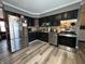 Kitchen features stainless steel appliances and dark cabinets at 1220 Victoria Dr, Lebanon, IN 46052