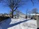 Snowy backyard with detached garage and large tree at 1318 N Lasalle St, Indianapolis, IN 46201
