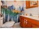 Clean bathroom with wood vanity and a nature-themed shower curtain at 1405 Sheek Rd, Greenwood, IN 46143