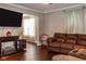 Brown leather sectional sofa and dark hardwood floors at 1405 Sheek Rd, Greenwood, IN 46143