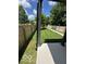 Backyard view showcasing a well-kept lawn, wooden fences, and porch columns at 1656 Roosevelt Ave, Indianapolis, IN 46218