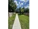 Spacious backyard with a long walkway, fenced on both sides providing privacy at 1656 Roosevelt Ave, Indianapolis, IN 46218