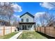 A fenced backyard featuring a well-maintained lawn and concrete walkway leading to the house at 1656 Roosevelt Ave, Indianapolis, IN 46218
