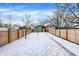 Snow-covered backyard with detached garage at 1656 Roosevelt Ave, Indianapolis, IN 46218