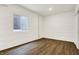 Finished basement room with white brick and wood flooring at 1656 Roosevelt Ave, Indianapolis, IN 46218