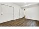 Finished basement room with white brick and wood flooring at 1656 Roosevelt Ave, Indianapolis, IN 46218