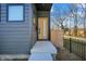 Welcoming front entrance featuring a concrete porch, modern door, and sleek dark gray exterior paneling at 1656 Roosevelt Ave, Indianapolis, IN 46218