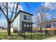 Modern two-story house featuring a fenced front yard and landscaped surroundings with a well-maintained lawn at 1656 Roosevelt Ave, Indianapolis, IN 46218