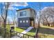 A modern two-story home with clean lines, a welcoming front entrance, and a well-maintained lawn and black metal fence at 1656 Roosevelt Ave, Indianapolis, IN 46218