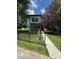 Modern two-story home with a well-manicured lawn and a charming black fence at 1656 Roosevelt Ave, Indianapolis, IN 46218