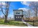 Charming two-story home with modern design elements and a well-manicured front yard and black metal fence at 1656 Roosevelt Ave, Indianapolis, IN 46218