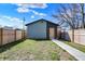 View of the backyard garage with a private walkway and a privacy fence at 1656 Roosevelt Ave, Indianapolis, IN 46218
