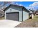 Garage with a large door and siding that matches the style of the home at 1656 Roosevelt Ave, Indianapolis, IN 46218