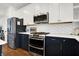 Kitchen features stainless steel appliances and hexagon tile backsplash at 1656 Roosevelt Ave, Indianapolis, IN 46218