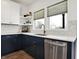 Modern kitchen with white cabinets, hexagon tile, and stainless steel appliances at 1656 Roosevelt Ave, Indianapolis, IN 46218