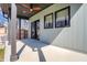 Spacious covered patio area with concrete flooring, ceiling fan, and views of the fenced backyard at 1656 Roosevelt Ave, Indianapolis, IN 46218