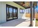 Covered patio with a concrete floor, ceiling fan, and sliding glass doors overlooking the backyard at 1656 Roosevelt Ave, Indianapolis, IN 46218