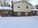 Back exterior of house with snow at 1726 Mccollough Dr, Indianapolis, IN 46260