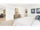 Bright main bedroom features a wooden mirror above a dresser and access to a closet and bathroom at 18632 Walsh Way, Westfield, IN 46074