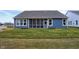 A blue house with a screened-in back porch and a green lawn leading to a newly installed yard at 19341 Sumrall Pl, Westfield, IN 46074